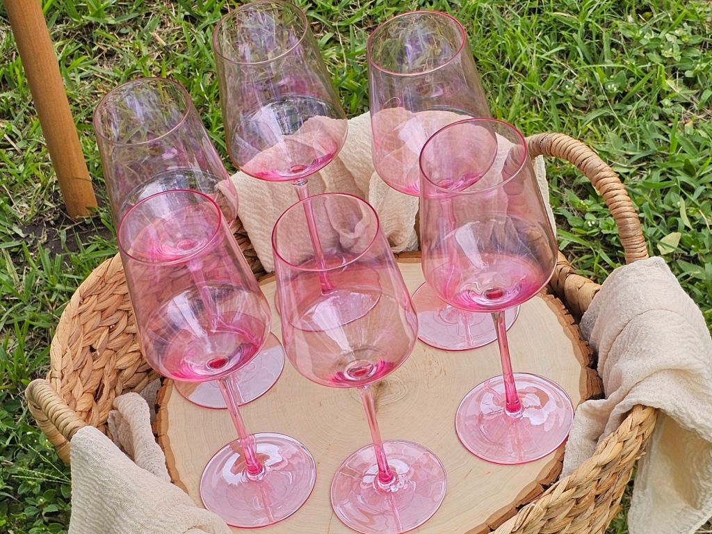 Pink glasses sitting in a basket.